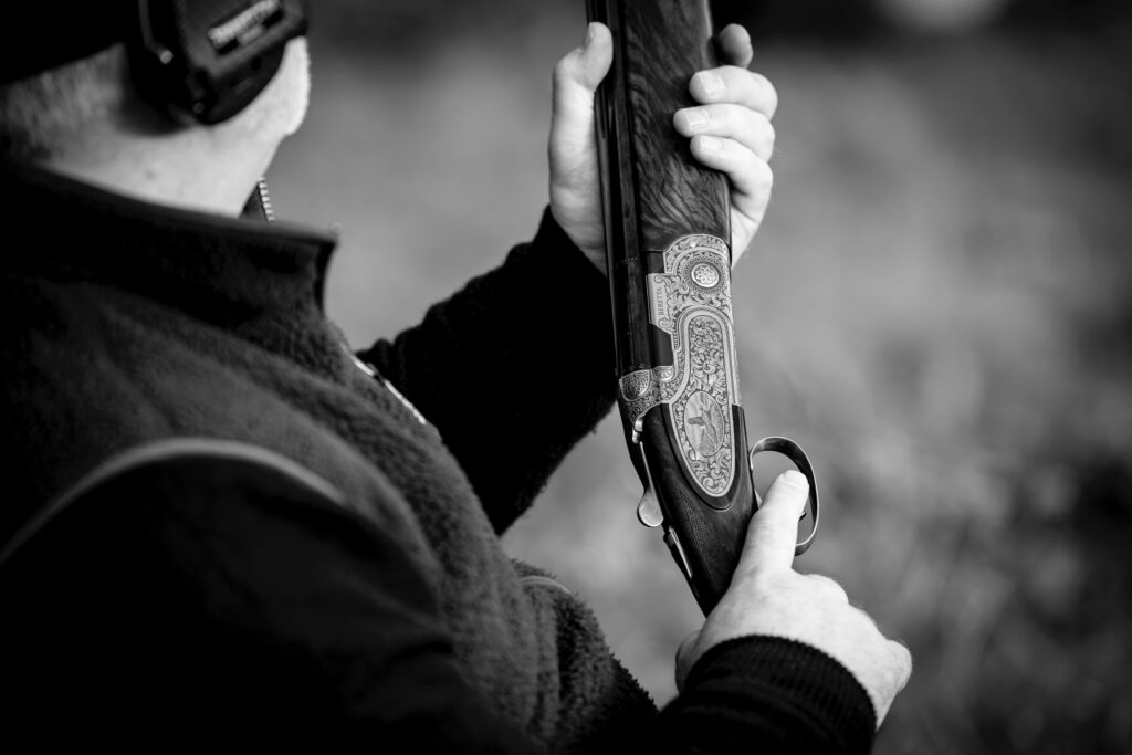 Game shooter holding a shotgun during a traditional British shooting day