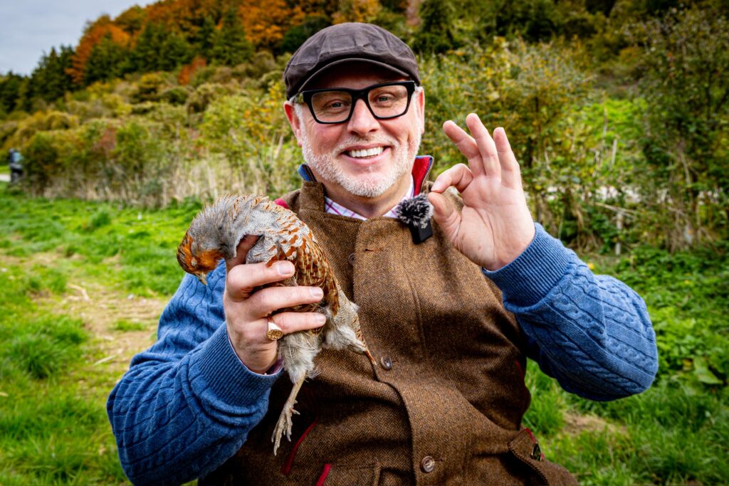 Game shooter holding a bird during a traditional country sports day
